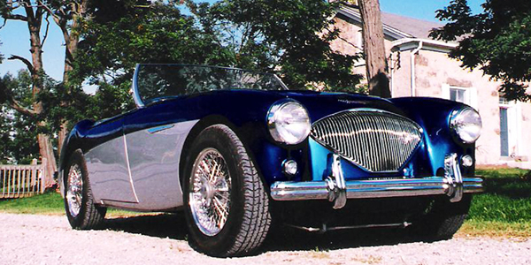 Blue of Silver Austin Healey in front of a house